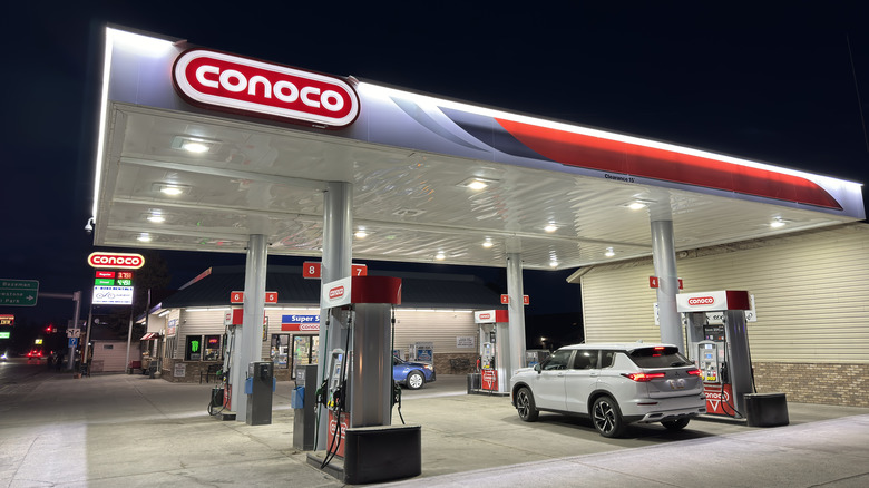 Conoco gas station with car refueling at night