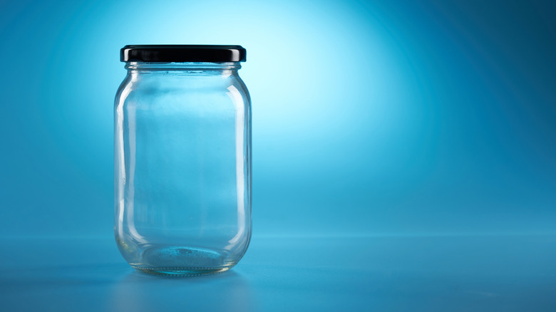 an empty jar on blue background