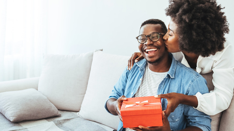 Woman giving gift to man