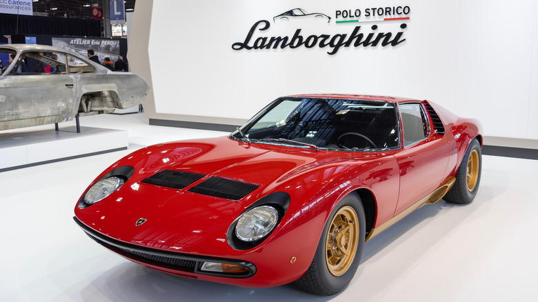 a red Lamborghini Miura SV in a showroom