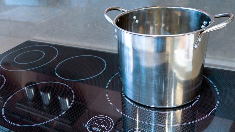 stove with pot sitting on a burner