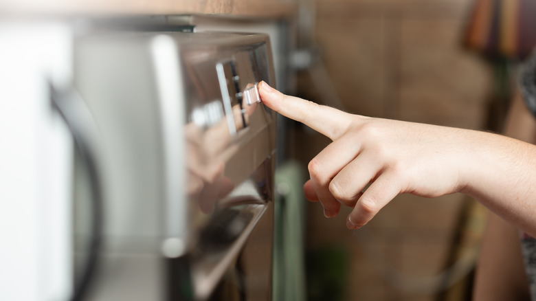 person setting the dishwasher dry cycle