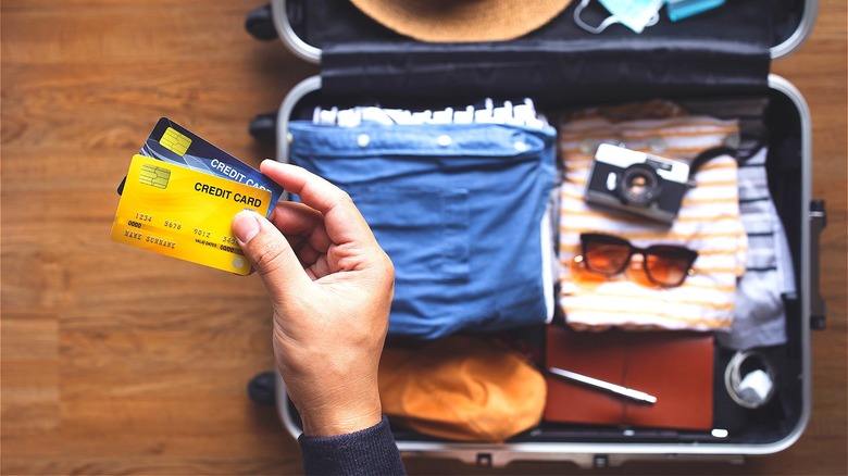 Person packing credit cards for travel