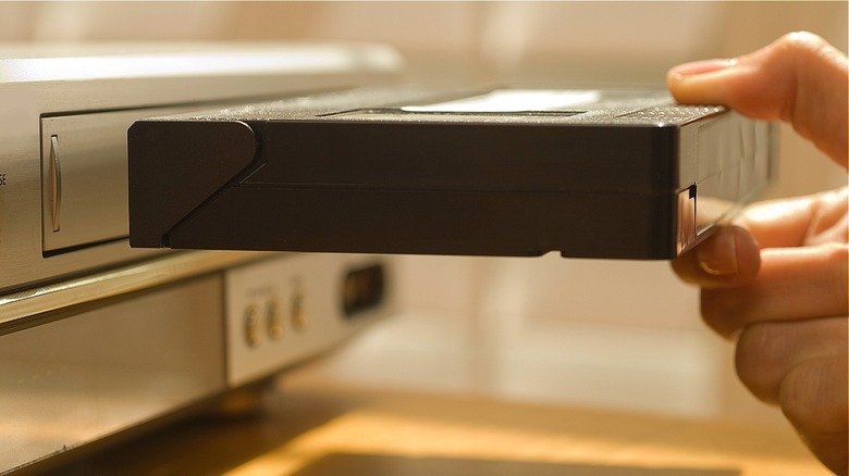 Loading VHS tape into player