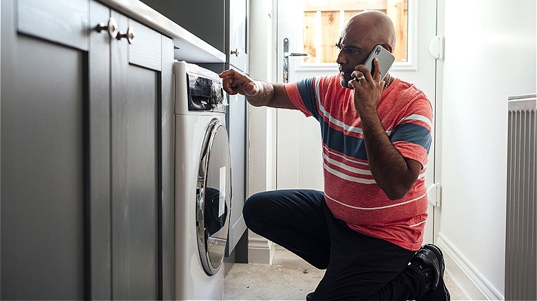 Person inspecting washing machine