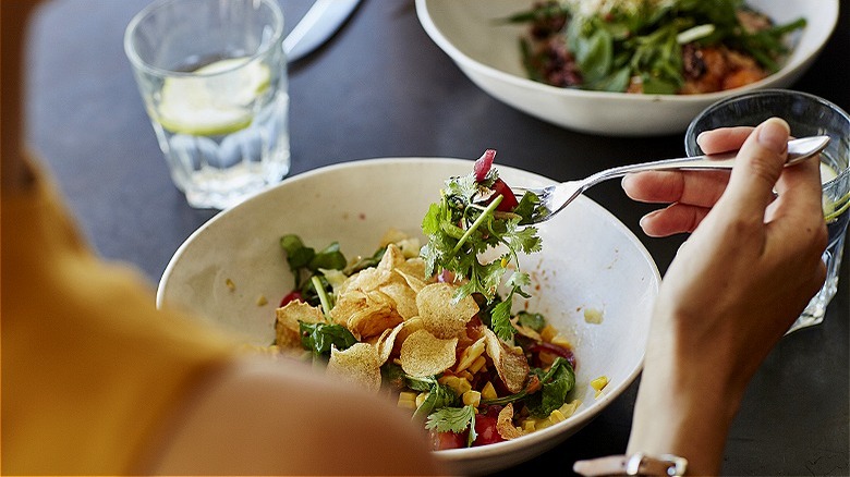 Person eating salad