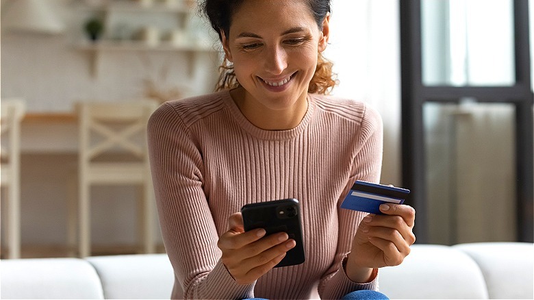 Person holding phone and card