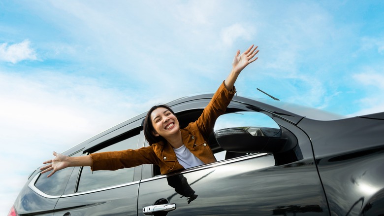 woman leaning out of car