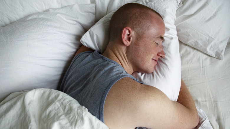 man sleeping with pillows