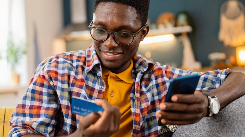 man holding credit card