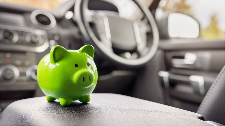 Green piggy bank inside car