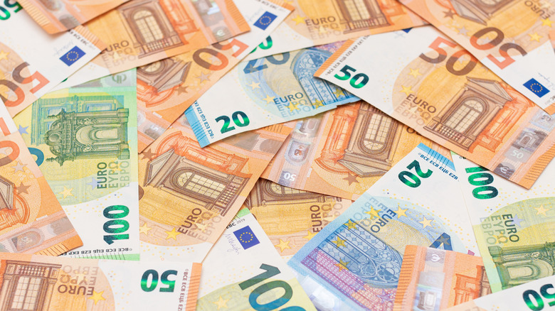 A pile of various euro bills in 20, 50, and 100 amounts