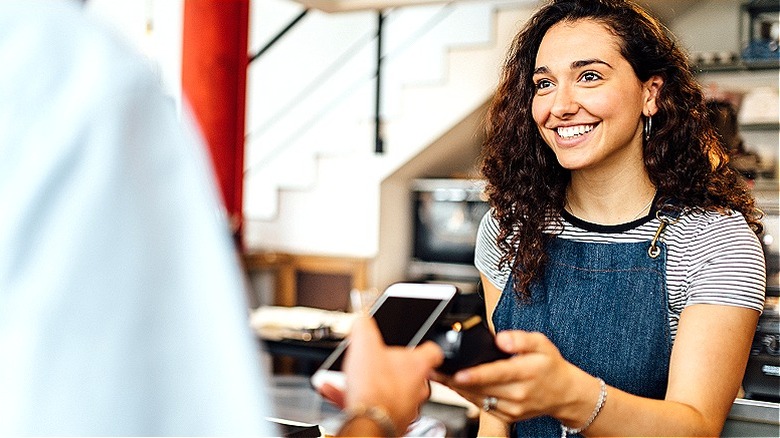 Person paying barista