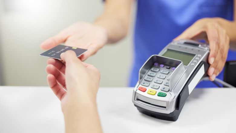 Person making a payment at doctors office.