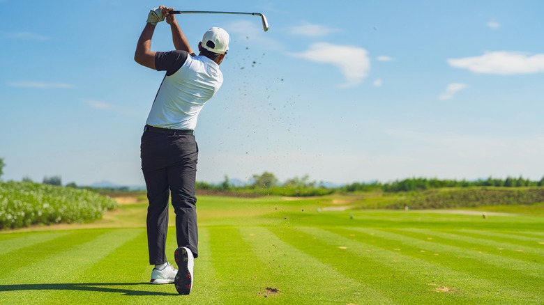 Golfer hitting a ball