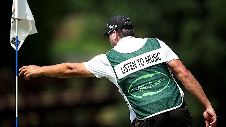 PGA caddie removing flagstick