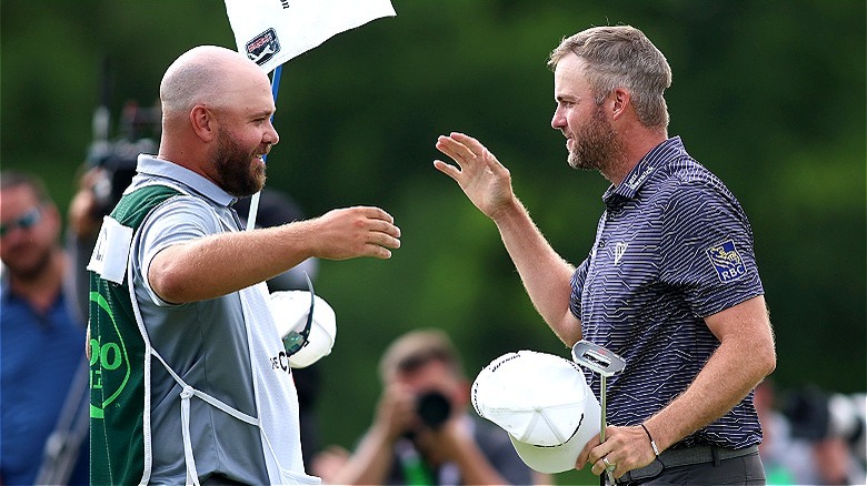 Golfer and caddie celebrating win