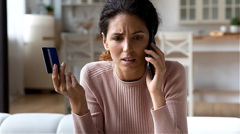 distressed person holding credit card