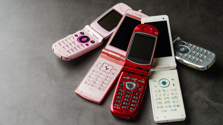 Old flip phone models on a table