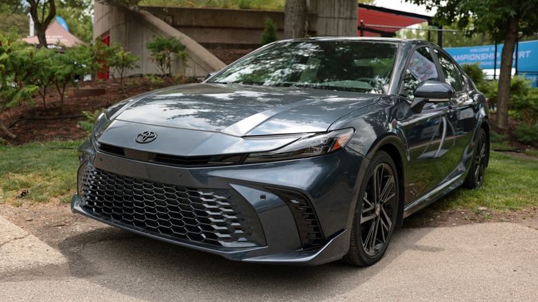 Gray Toyota Camry parked outdoors, viewed from the front at an angle