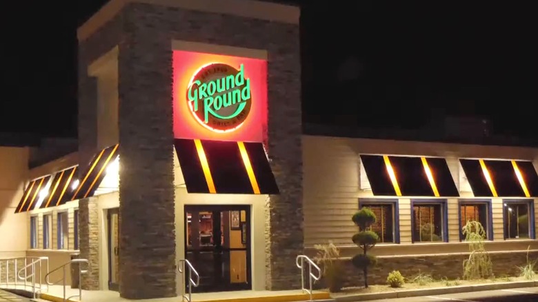 Thr exterior of The Ground Round restaurant at night