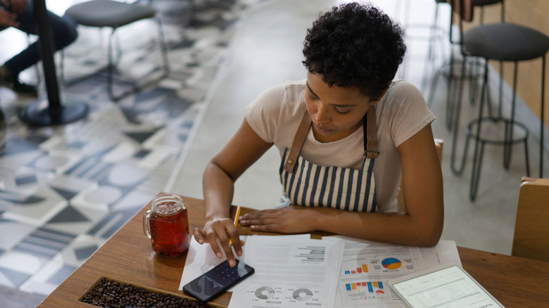 Restaurant owner calculates business expenses