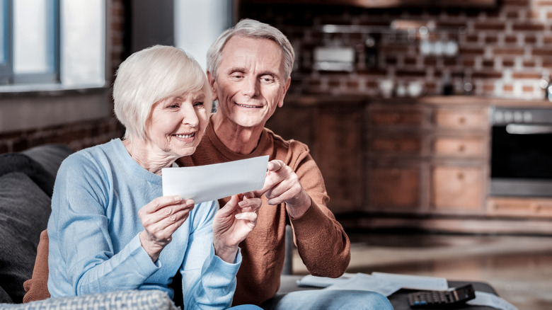 Older couple looks over check