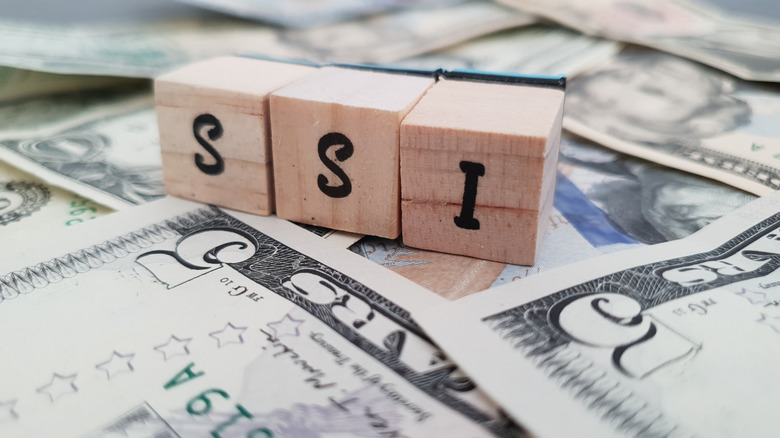 SSI blocks on top of dollar bills