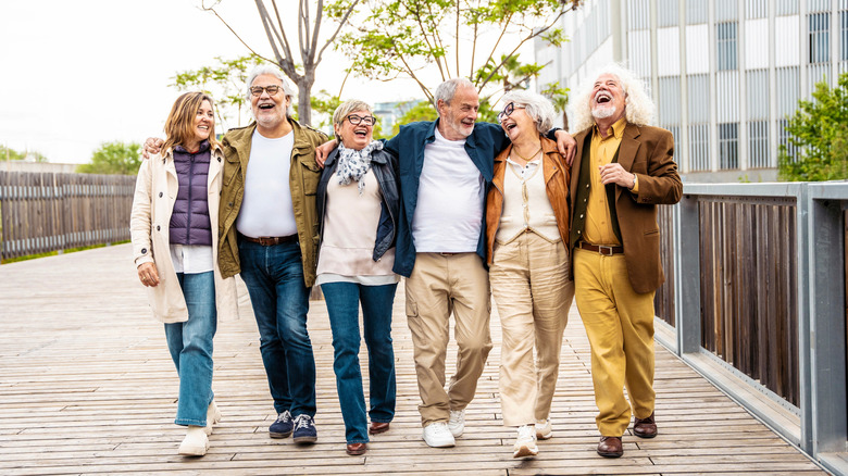 group of seniors laughing and walking