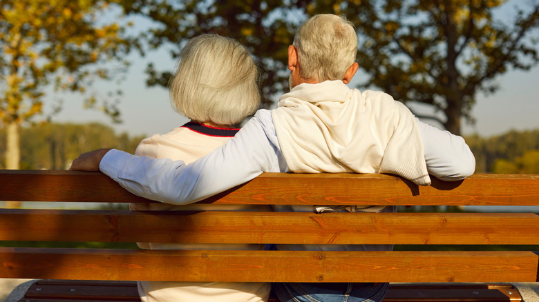 retired couple sitting on bench