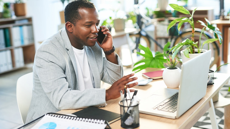 professional booking travel from his desk at work