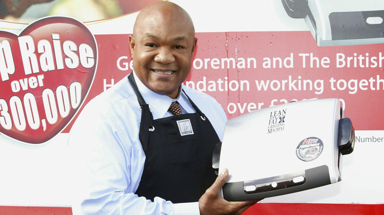 George Foreman holding a George Foreman grill commemorating the brand's partnership with The British Heart Foundation