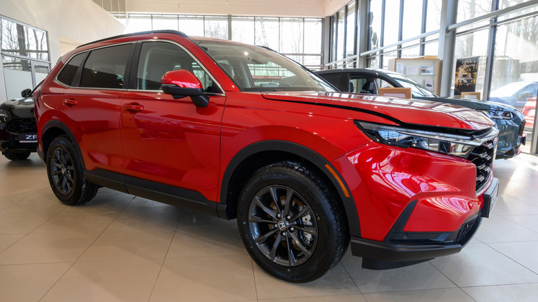 A bright red 2026 Honda CR-V in a showroom