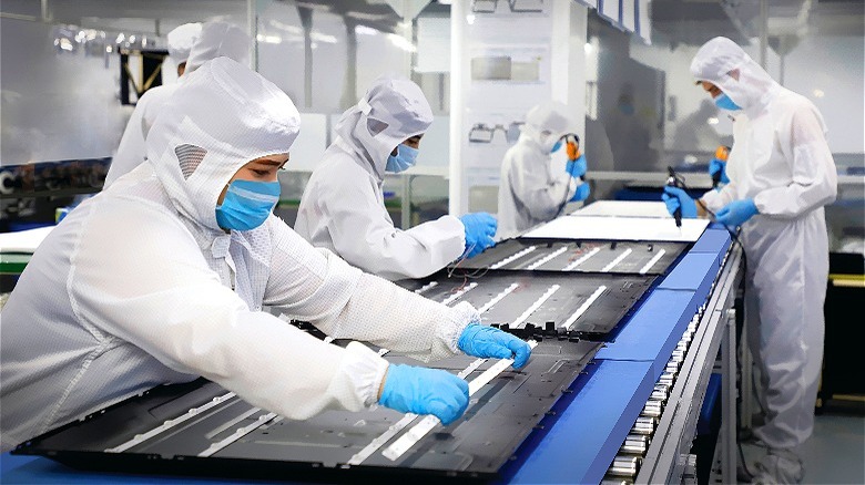 People working in television factory