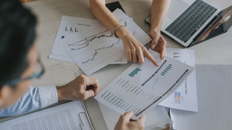 people looking over financial data