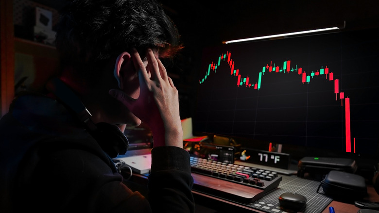 A concerned man viewing a chart on a computer
