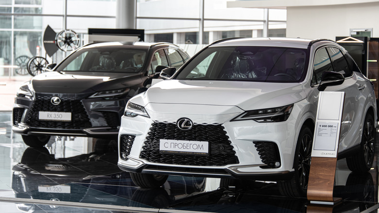 A pair of Lexus RX 350 SUVs are displayed in a dealership in Russia.