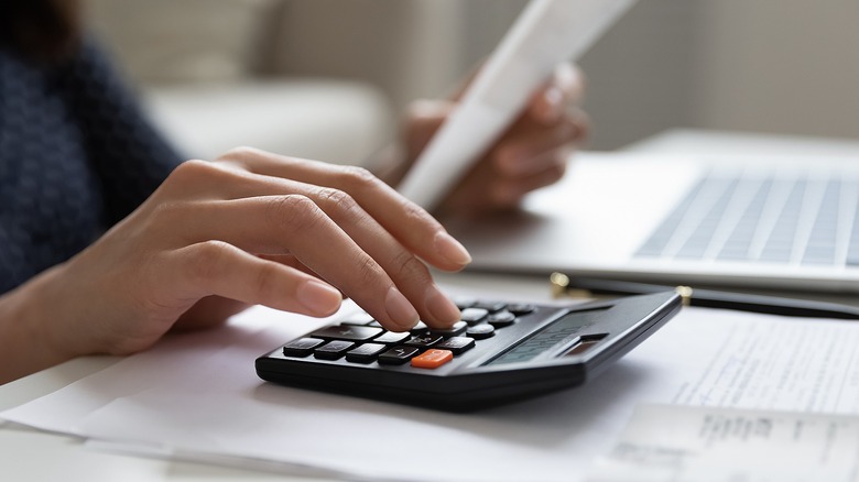 Person calculating with calculator