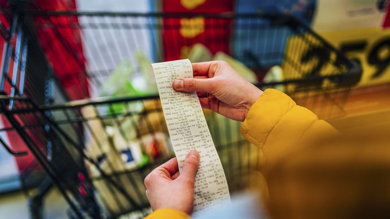 Person looking at grocery store receipt