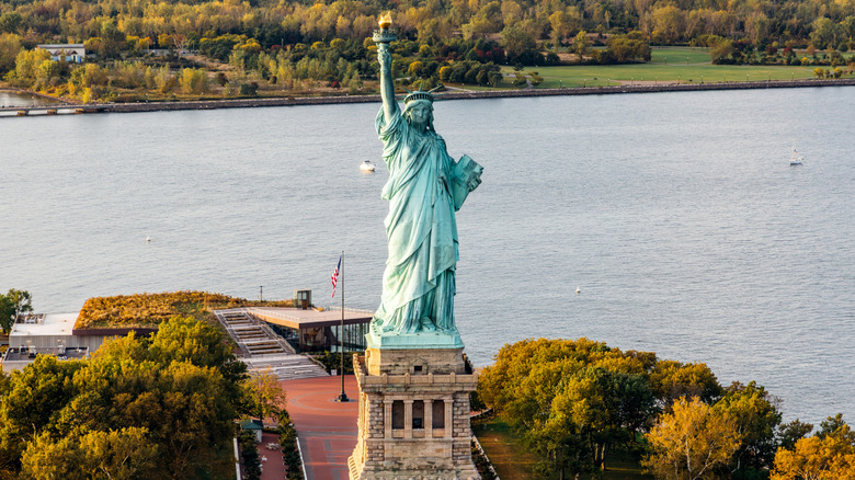 Statue of Liberty surrounded by water and trees