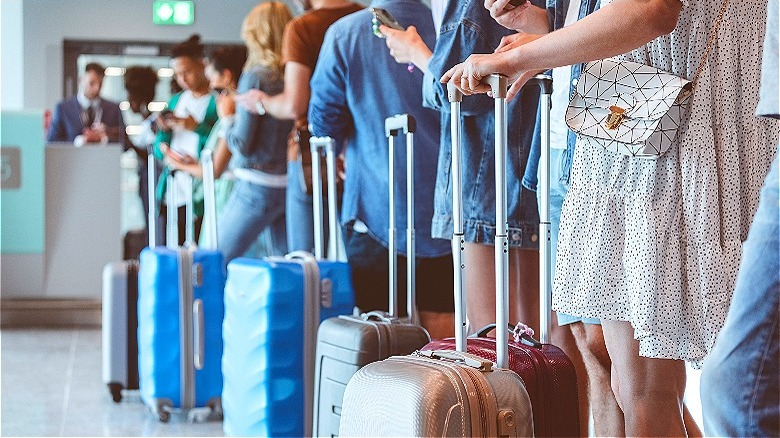 People in line with luggage