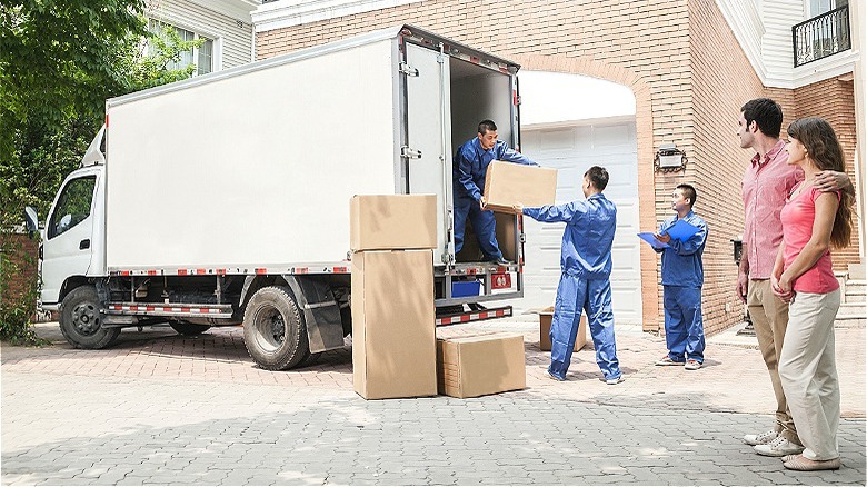 Couple watching house movers working
