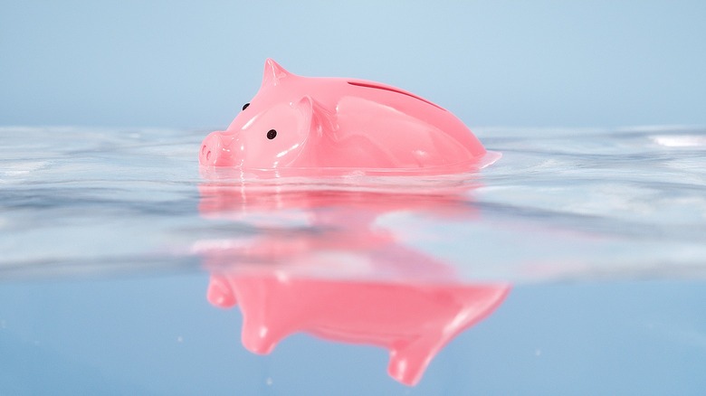 Piggy bank sinking in water