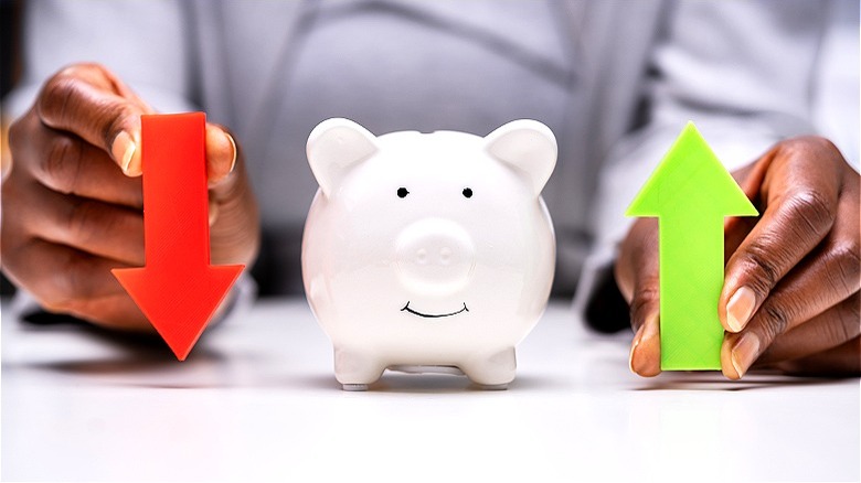 Piggy bank savings with arrows