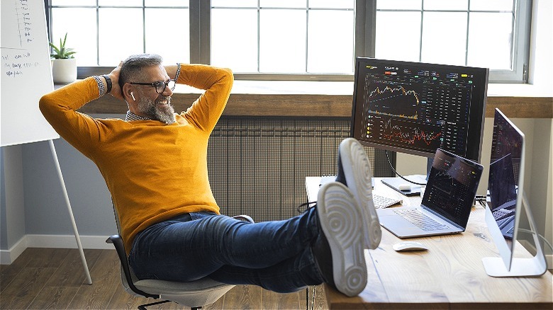 Person smiling, viewing chart analytics