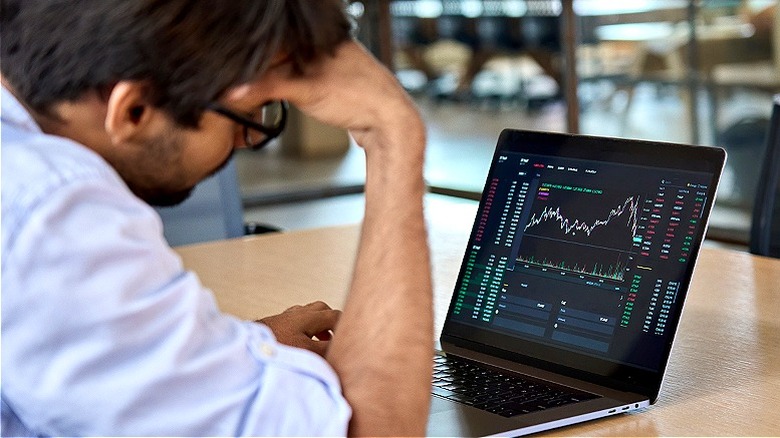 Person frustrated, reviewing stock price