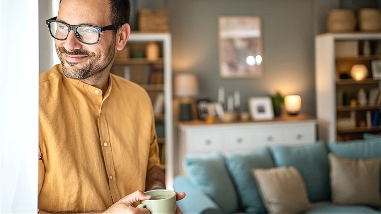 Person smiling while enjoying coffee
