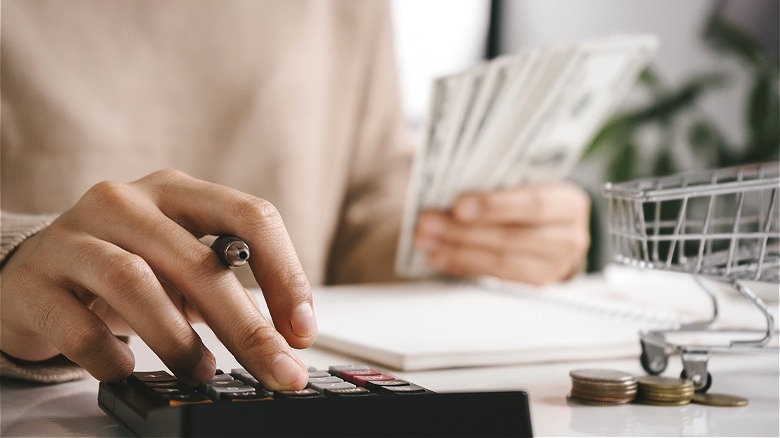 Person holding money, making calculations