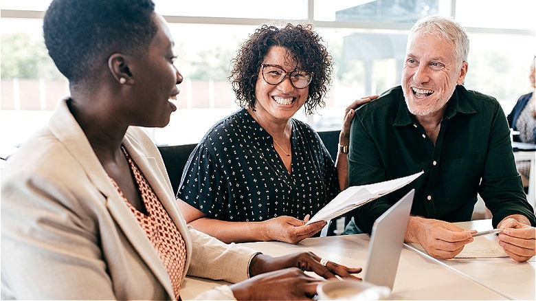 Financial adviser smiling with couple
