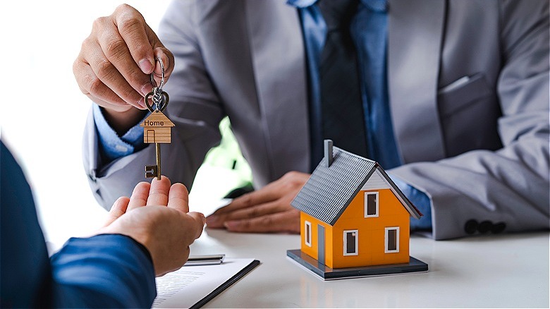 Person handing over house keys